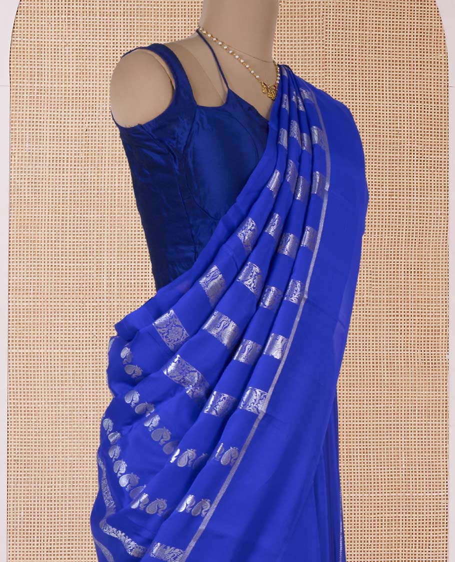 Blue floral creeper, peacock, elephant motifs woven Mysore silk saree, self-border, and traditional zari pallu