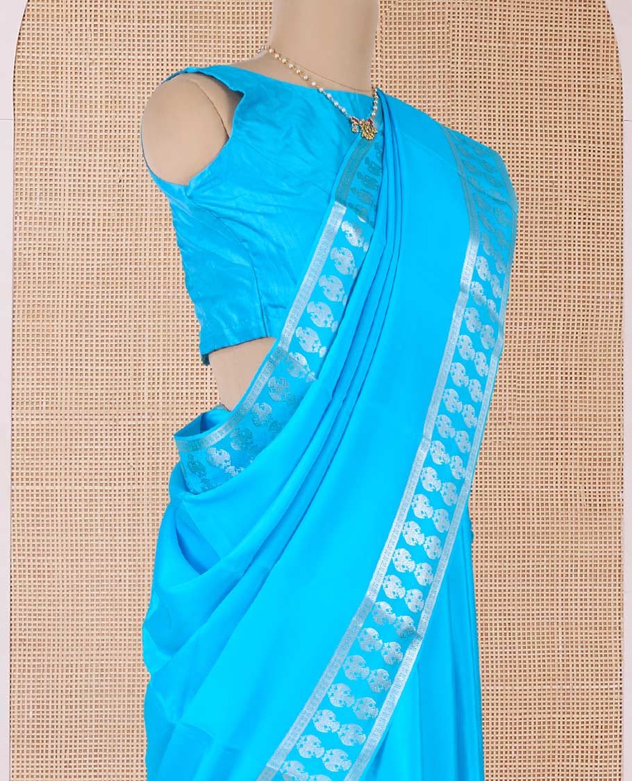 Blue plain Mysore silk saree, two-headed eagle zari woven border, and pallu of two-headed eagle motifs