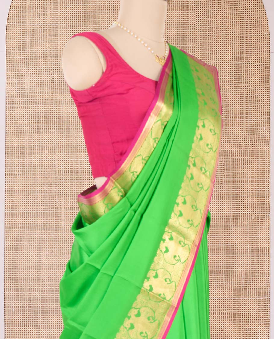 Parrot green plain Mysore silk saree, two-headed eagle zari border, and pallu steeped with two-headed eagle motifs