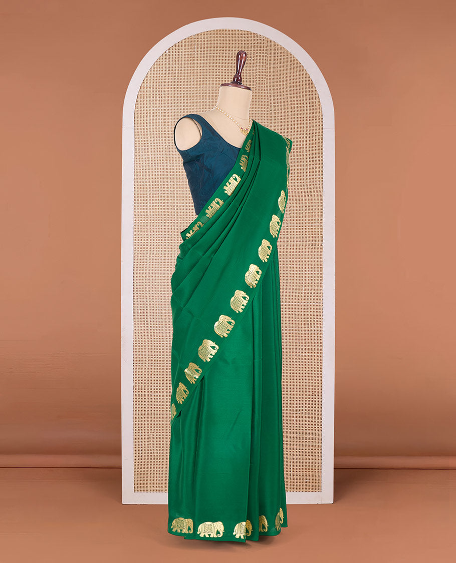 Green plain Mysore silk saree with elephant motifs zari border, and pallu of miniatures of elephant motifs