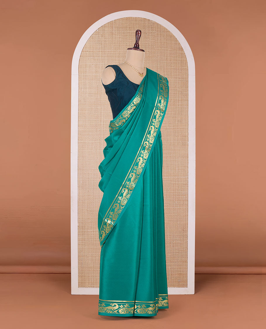 Green plain Mysore silk saree, peacock motifs zari border l, and zari striped pallu