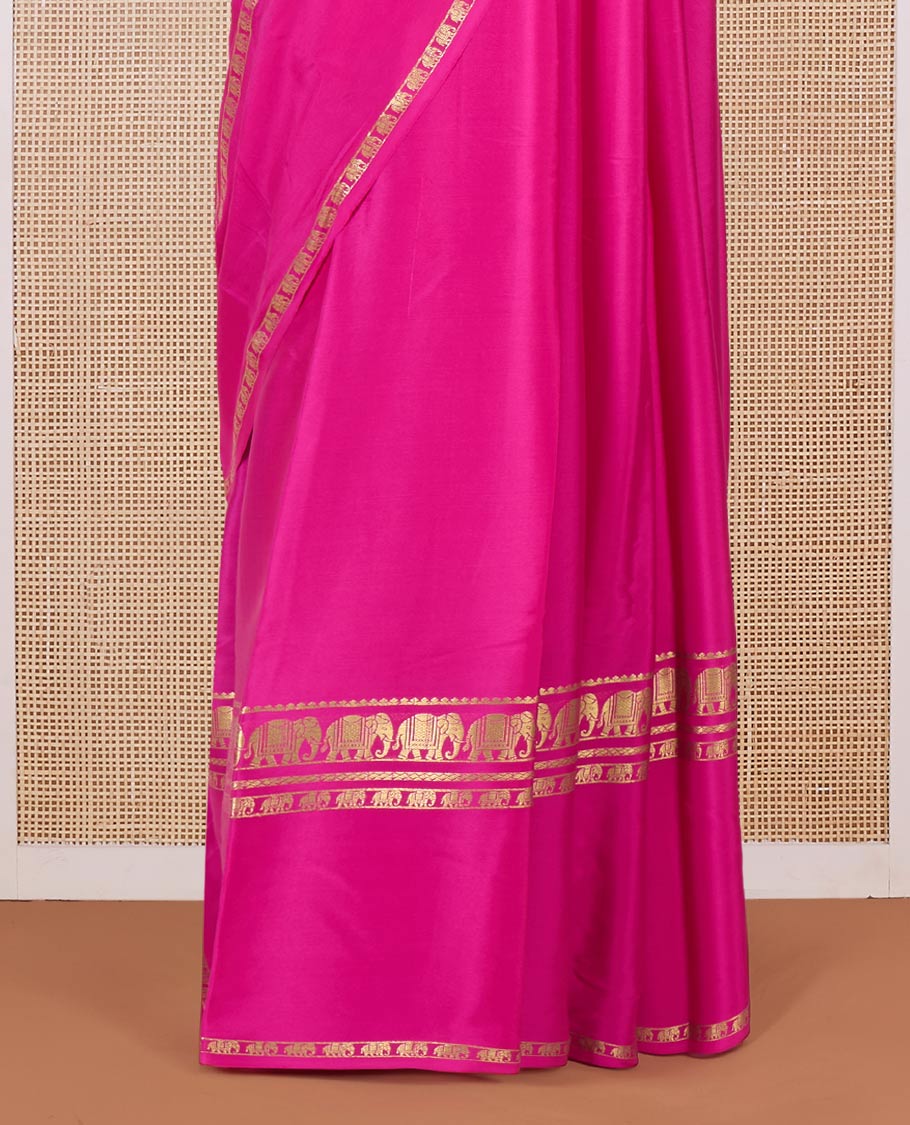 Pink plain Mysore silk saree, traditional zari border of elephant motifs, and zari striped pallu