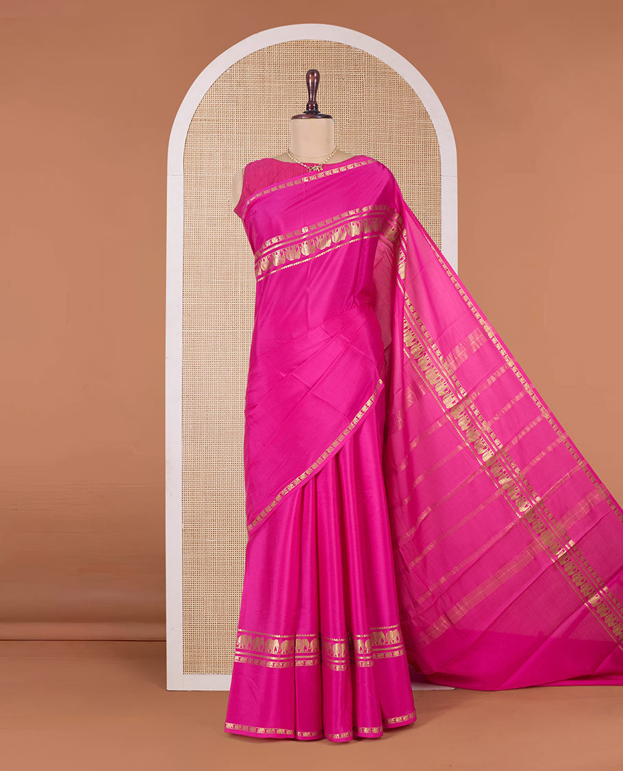 Pink plain Mysore silk saree, traditional zari border of elephant motifs, and zari striped pallu
