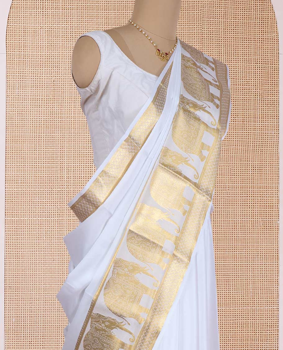 Cream plain Mysore silk saree, traditional zari border of elephant motifs, and pallu steeped with manga designs