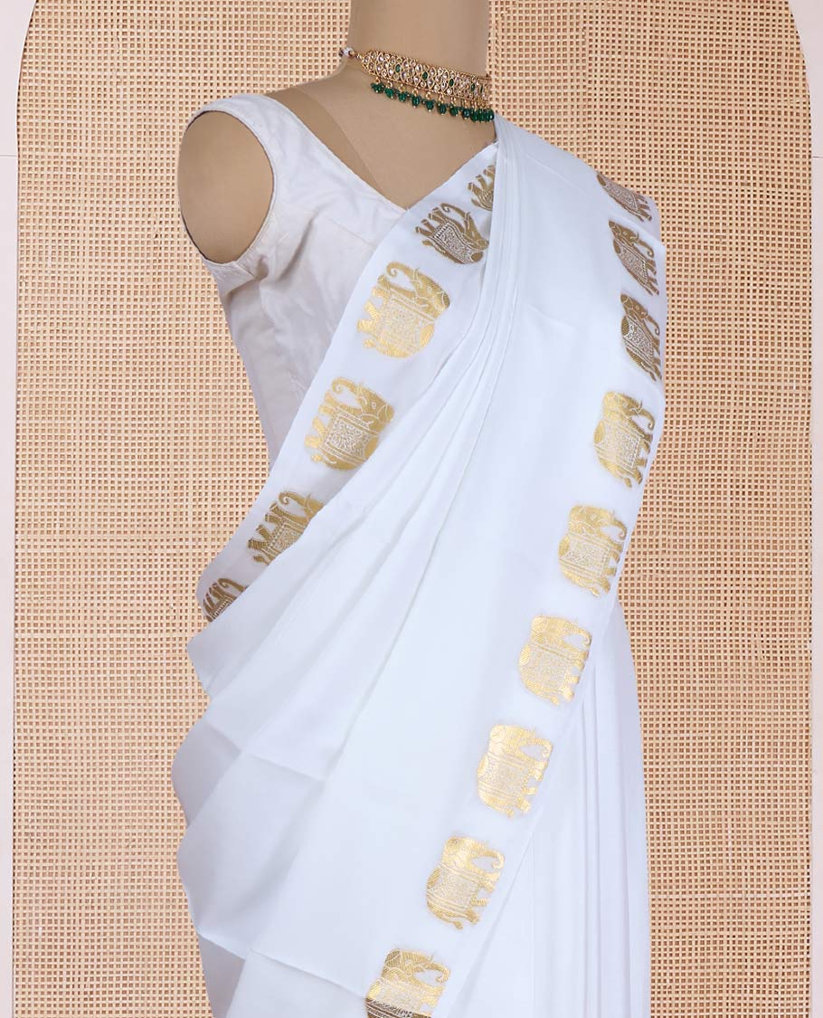 Cream plain Mysore silk saree, zari border of elephant motifs, and pallu steeped with elephant motifs