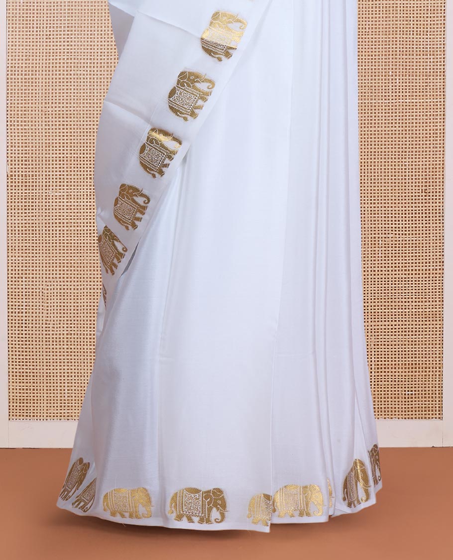 Cream plain Mysore silk saree, zari border of elephant motifs, and pallu steeped with elephant motifs