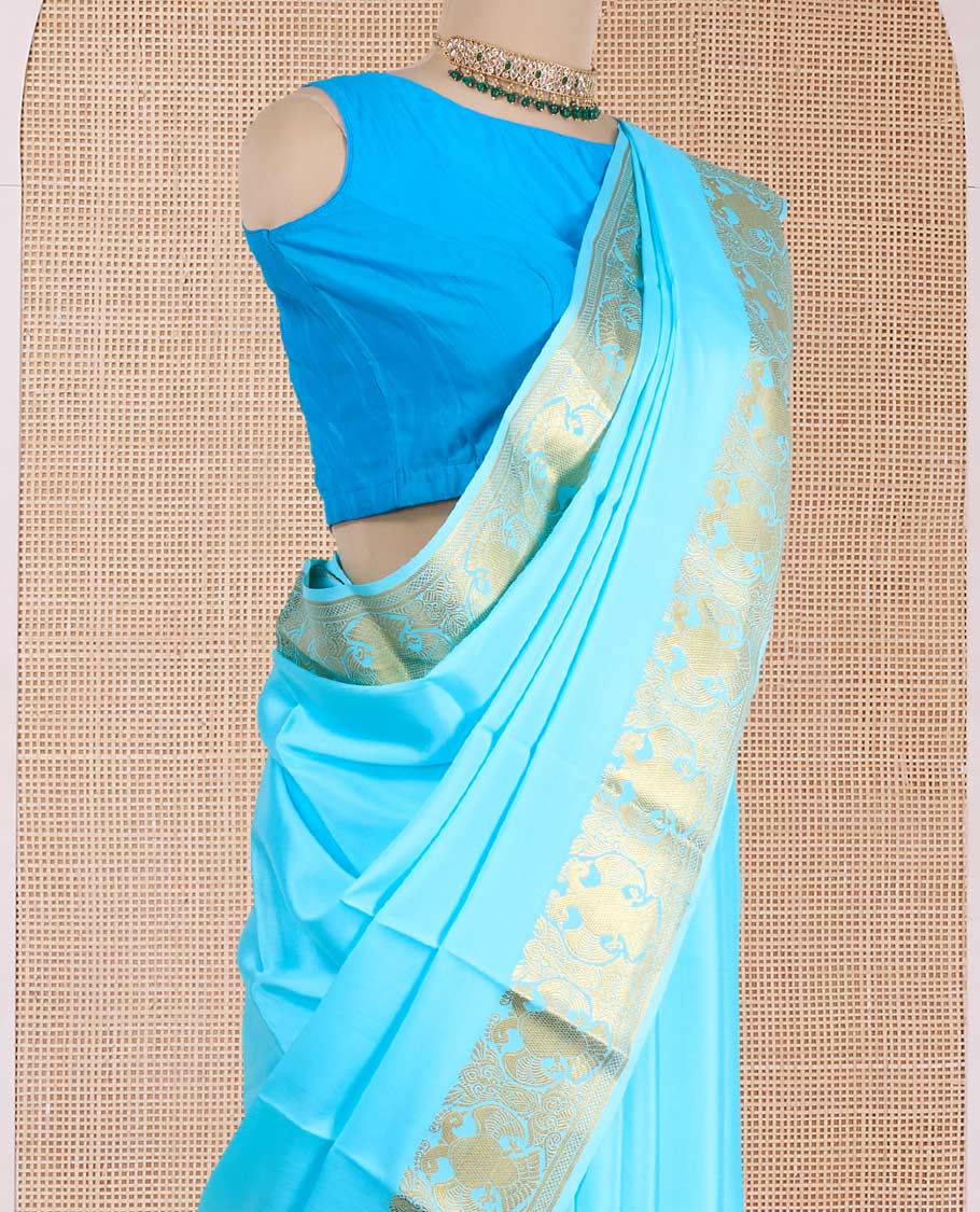 Blue plain Mysore silk saree, zari border of two-headed eagle motifs, and pallu steeped with two-headed eagle motifs