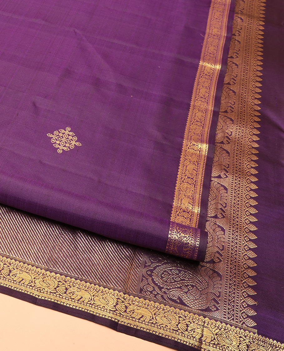 Purple Kanchipuram Silk Saree, Enriched with Kolam Buttas All Over Its Body, Highlighted by Zari Border of Rekku, Muthu, Mayil, Yaanai, and Rettai Neli Designs, Pallu Gleamed with Diagonal Stripes and Mayil Designs, and Paired with a Matching Blouse