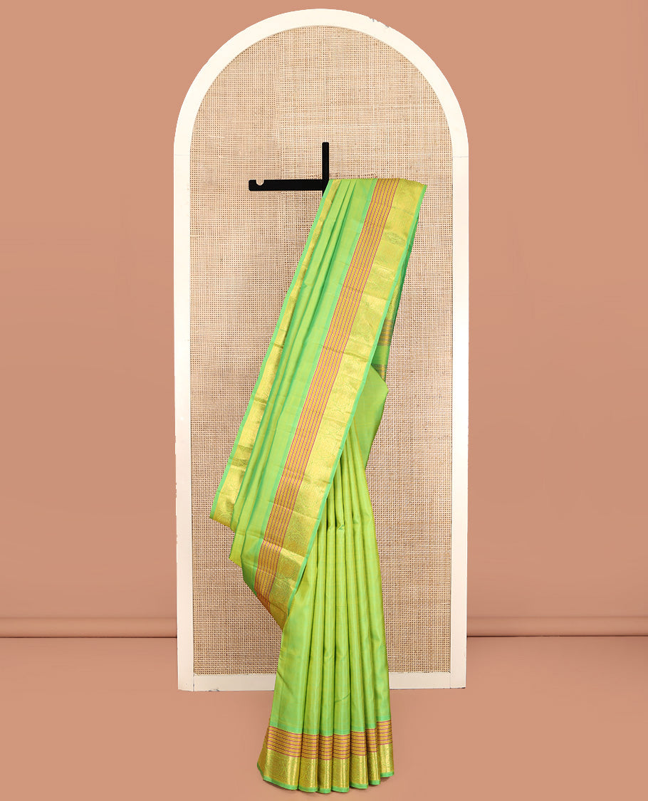 Green Plain Kanchipuram Silk Saree, Highlighted by Self-Border of Neli, and Round Iruthalai Pakshi Designs, Pallu of Same Design, and Paired with a Matching Blouse