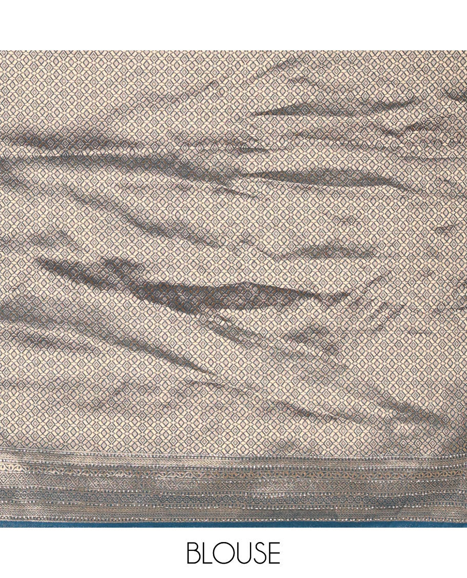 Cream and peacock blue half-saree, floral and bird printed nylon viscose crepe top, contrast traditional zari and stone work border, jacquard banaras blouse, and scallop stone work dhavani