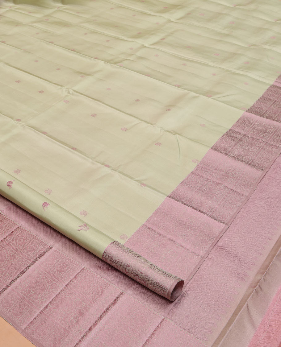 Green Kanchipuram Silk Saree, Subtly Enriched with Mayil-Chakram Buttas All Over Its Body, Complemented by a Contrast Border of Thilakam, Banaras, Mayil, Kathir, and Yaanai Designs, Pallu Steeped with Kamalam Designs, and Paired with a Contrast Blouse