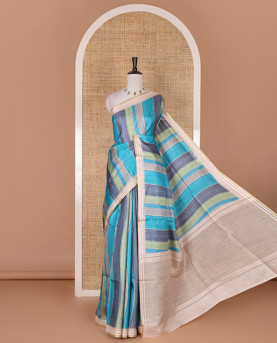 Multi color vertically striped semi-tussar saree, contrast resham thread border of temple and rudraksham motifs, striped pallu, and contrast striped printed blouse