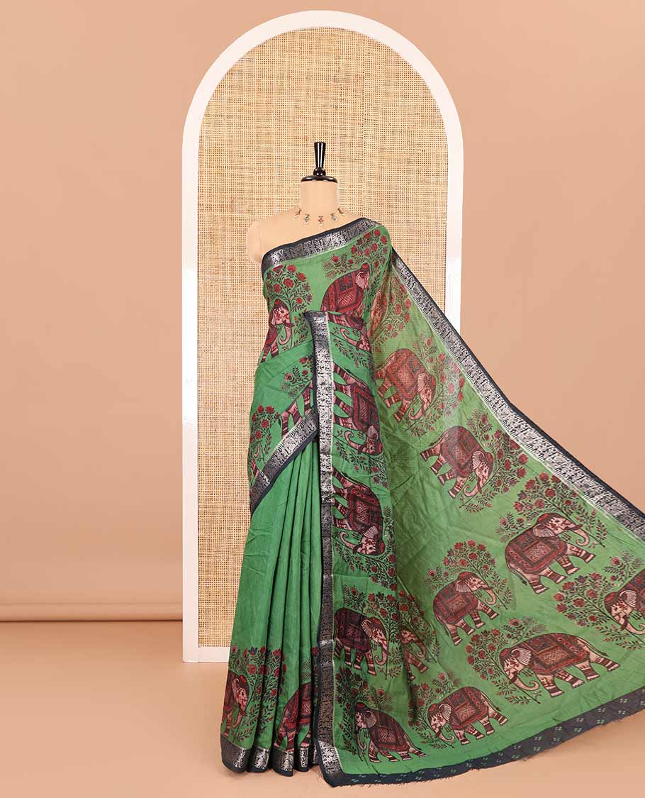 Green plain muslin cotton saree, contrast wedding-theme of floral and elephant motifs print, printed pallu, and a contrast buttas and zari bordered blouse