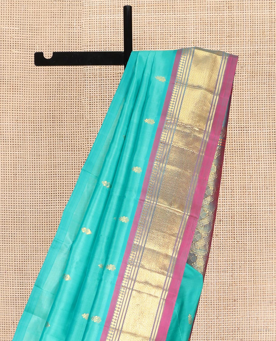 Blue Kanchipuram Silk Saree, Bedecked with Zari Buttas on Its Body, Complemented by a Contrast One-Sided Border of Panner Sombu, Banaras, and Jaal Designs, Pallu Features Floral Creeper Designs, and Comes Without a Blouse