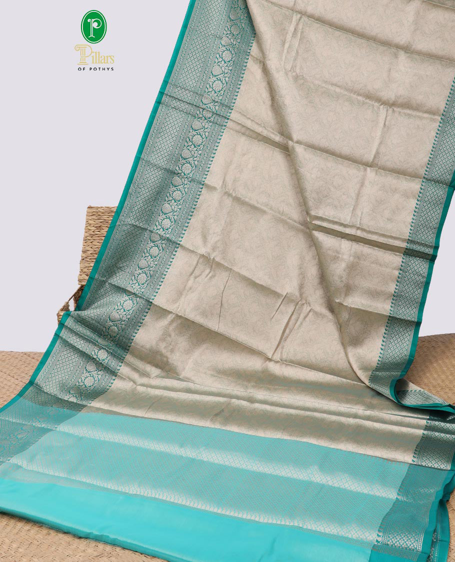 Grey floral jacquard semi tissue saree with contrast floral design border & zari design pallu