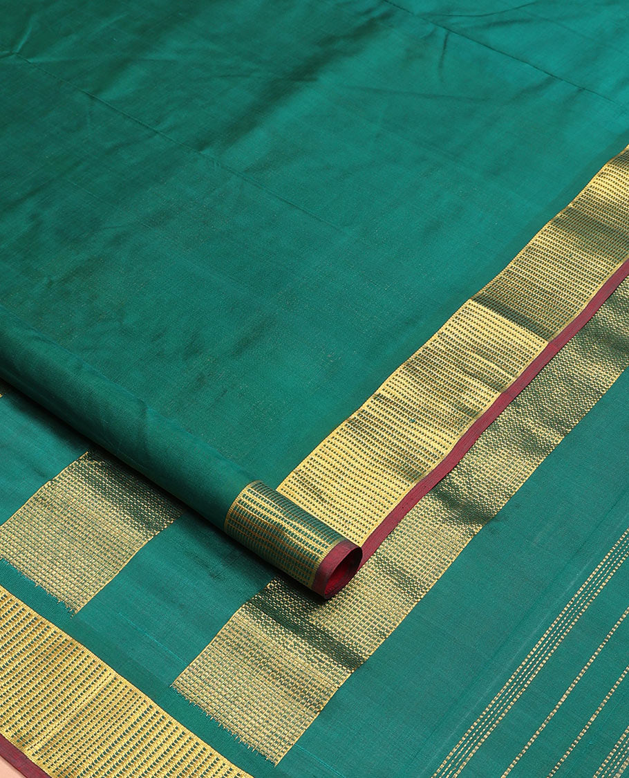 Dark green plain nine-yard silk saree, zari border, and pallu of zari designs