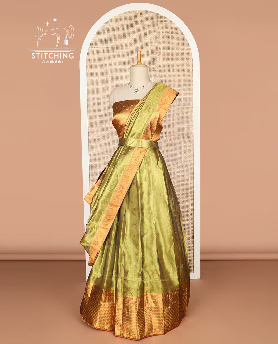 Light green buttas tissue half saree with contrast zari design border, zari design blouse & floral design dhavani