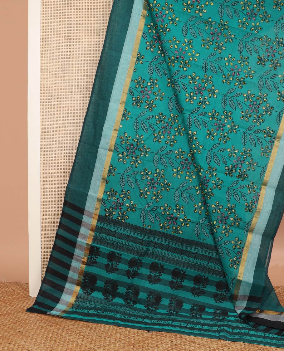 Teal blue floral and leaf printed chirala cotton saree, contrast zari border, and pallu of floral print