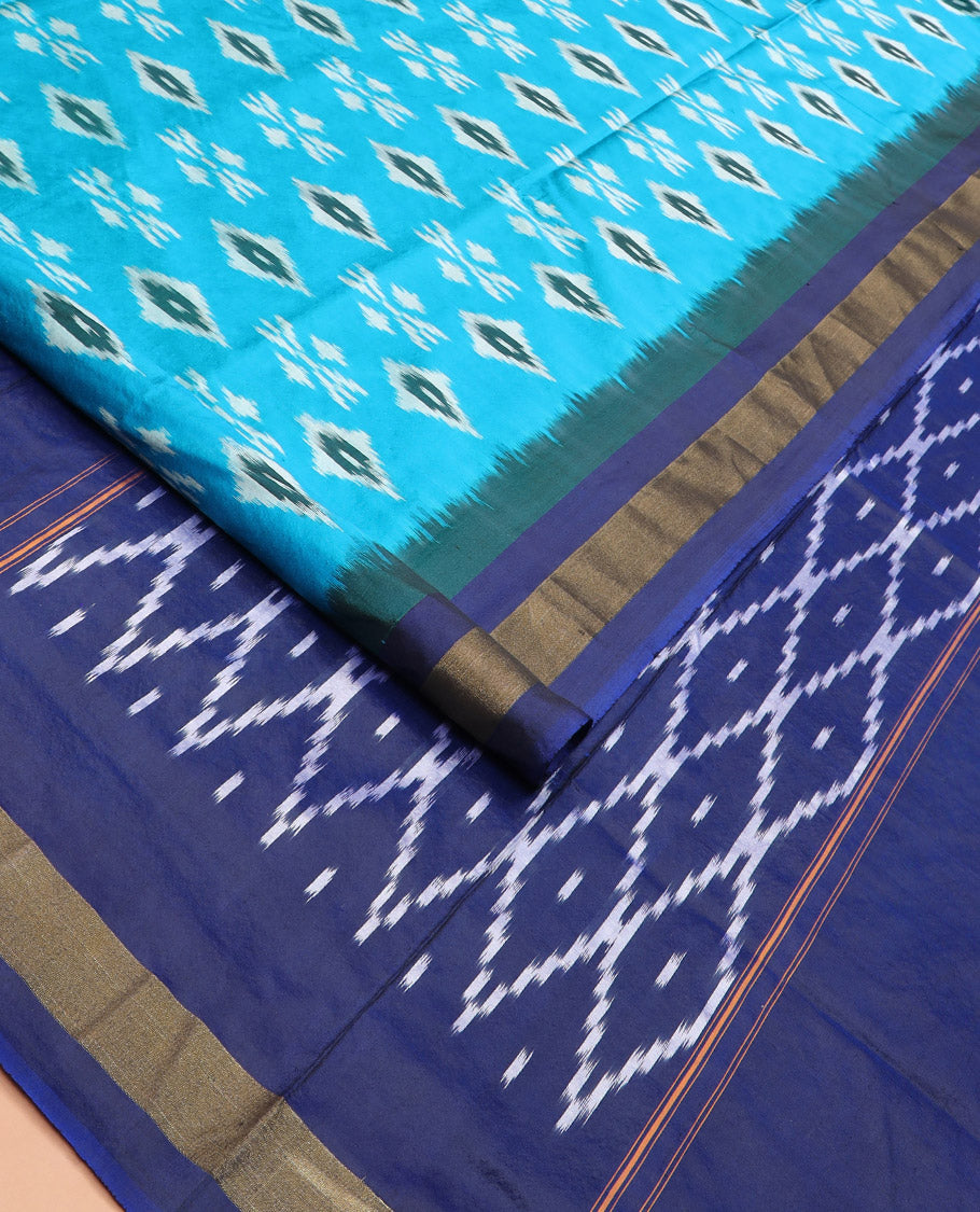 Blue Ikkat Silk Saree Decorated with Ikkat Buttas, Complemented by a Contrast Border, a Subtly Woven Pallu of Jaal Design, and a Contrast Plain Blouse