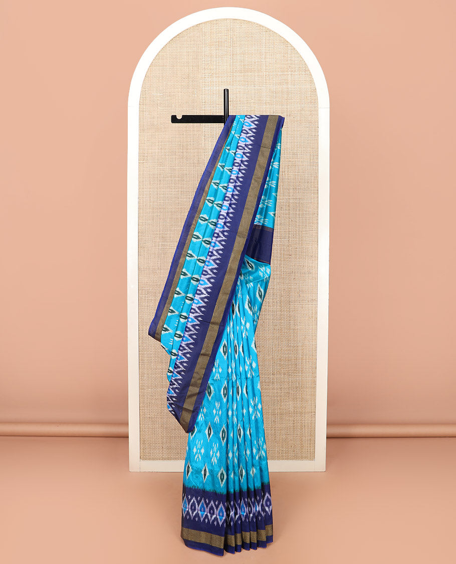 Blue Ikkat Silk Saree Decorated with Ikkat Buttas, Complemented by a Contrast Border, a Subtly Woven Pallu of Jaal Design, and a Contrast Plain Blouse