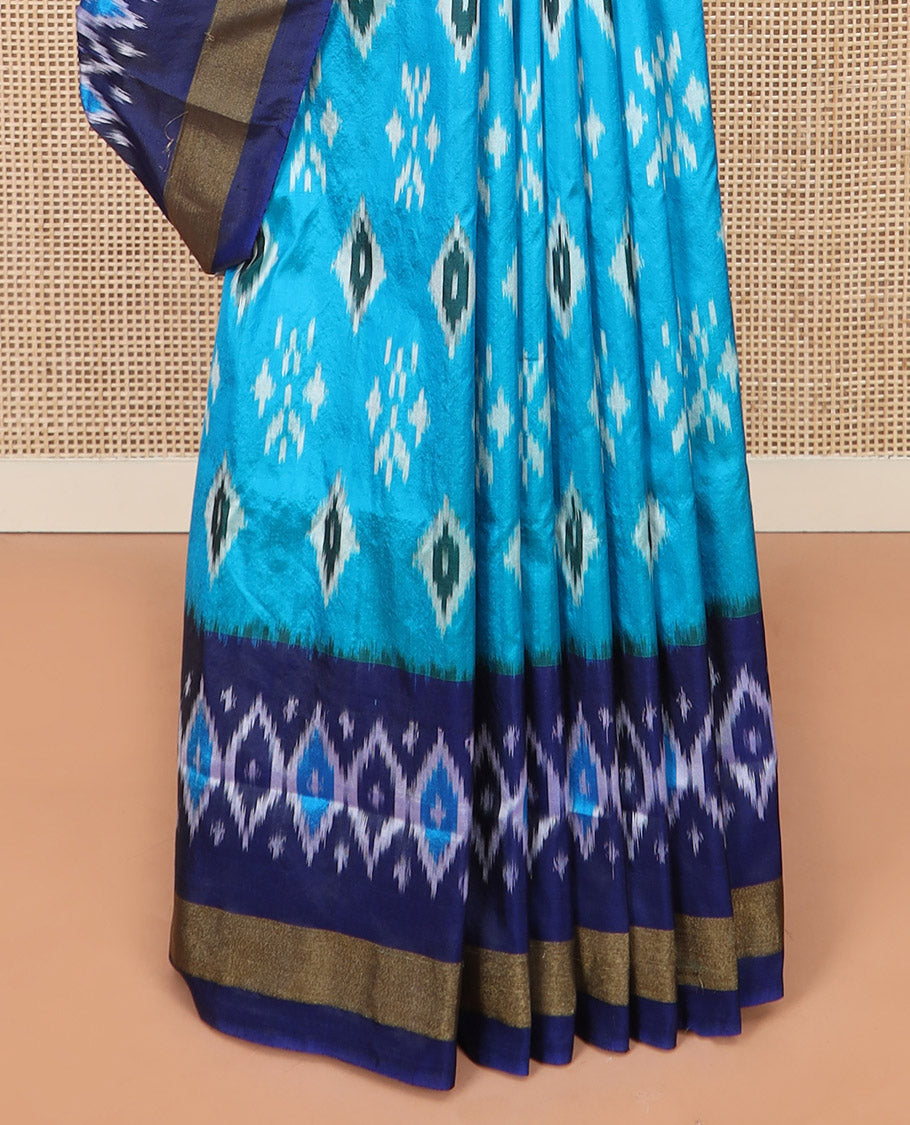 Blue Ikkat Silk Saree Decorated with Ikkat Buttas, Complemented by a Contrast Border, a Subtly Woven Pallu of Jaal Design, and a Contrast Plain Blouse