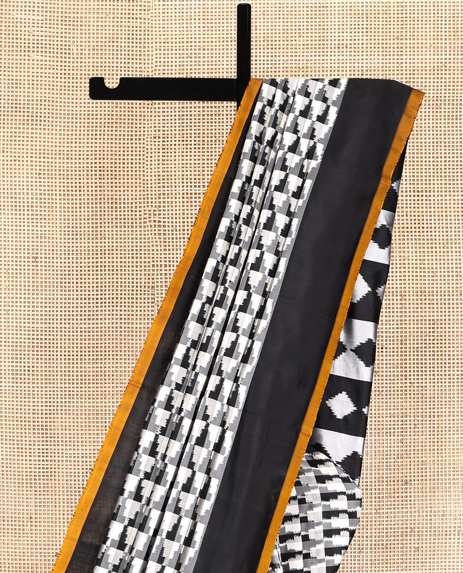 Black and White Pochampally Ikat Silk Saree, Spotlighted with Geometric Patterns on Its Body, Complemented by Contrast Border, Pallu of Diamond Patterns, and Paired with a Contrast Blouse