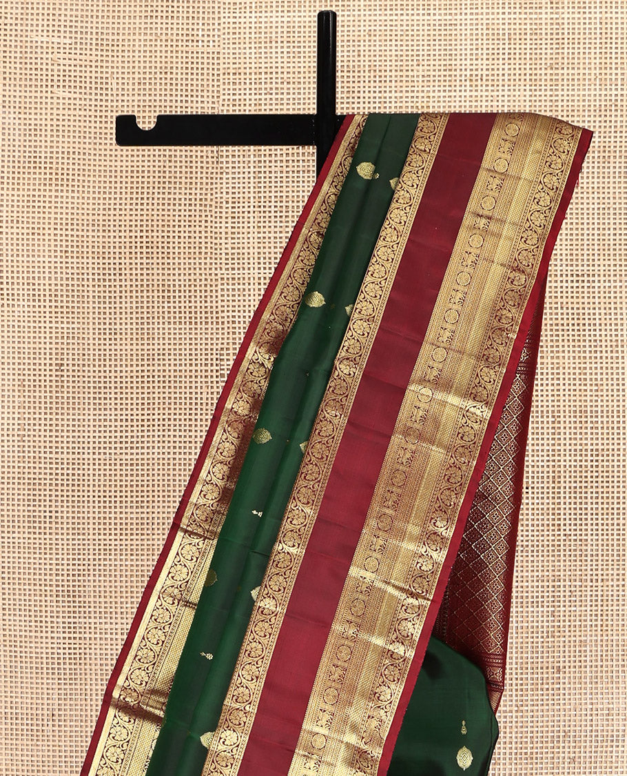 Green Kanchipuram Silk Saree, Woven with Zari Buttas All Over Its Body, Complemented by a Contrast Border of Rekku, Muthu, Kuthirai, Chakram, Mayil Kann, and Kodi Visiry Designs, Grand Jaal Pallu, and Paired with a Contrast Blouse