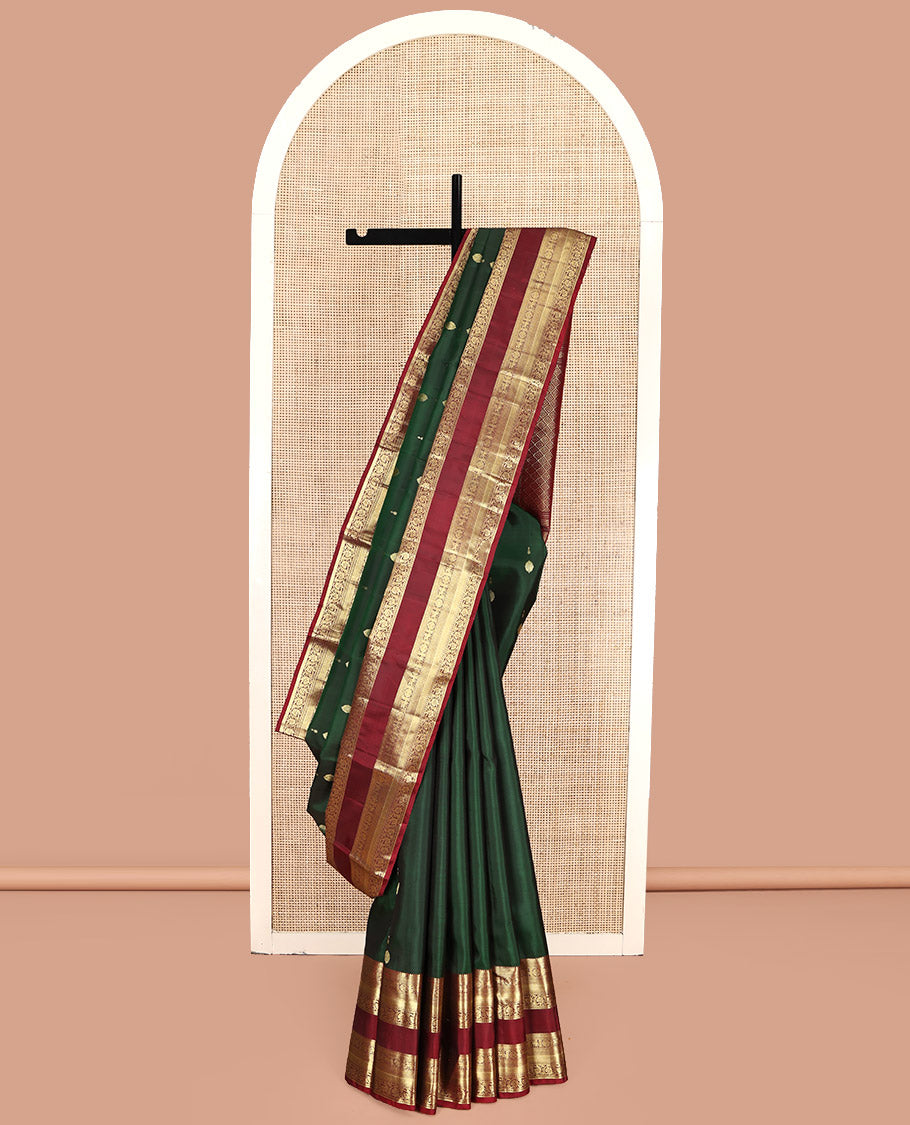 Green Kanchipuram Silk Saree, Woven with Zari Buttas All Over Its Body, Complemented by a Contrast Border of Rekku, Muthu, Kuthirai, Chakram, Mayil Kann, and Kodi Visiry Designs, Grand Jaal Pallu, and Paired with a Contrast Blouse