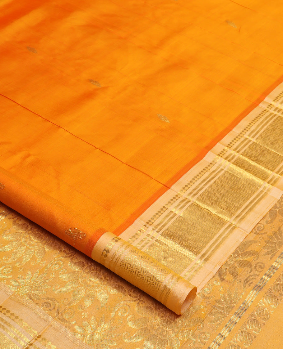 Orange zari buttas Kanchipuram silk saree, contrast one-sided border of paneer sombu, banaras, and jaal design, and zari design pallu
