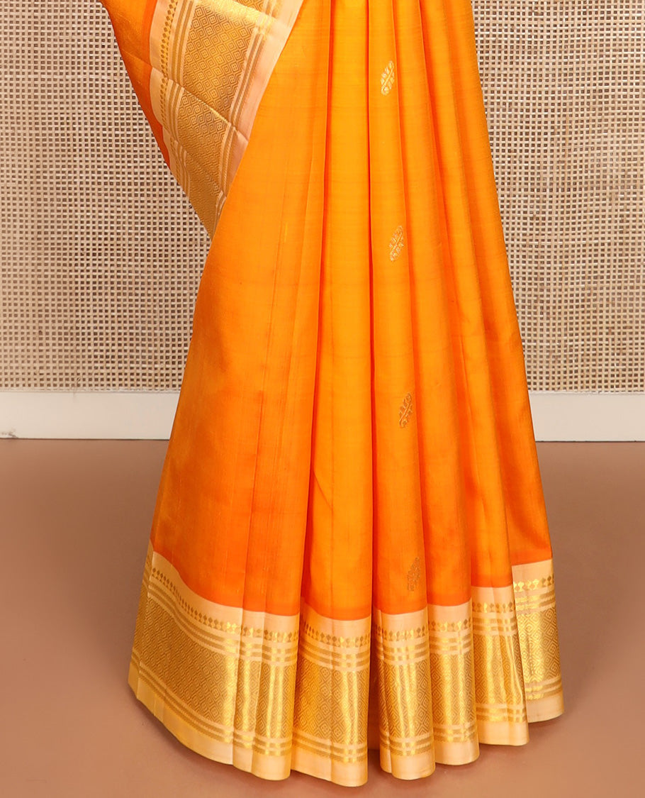 Orange zari buttas Kanchipuram silk saree, contrast one-sided border of paneer sombu, banaras, and jaal design, and zari design pallu