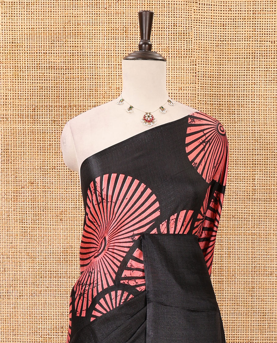 Black-base plain body khadi cotton saree with batik-style peach-color radiant sunburst design on its border & pallu, plain black blouse