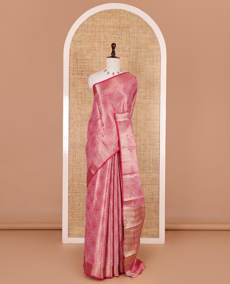 Rani pink scallop design tissue saree, zari striped border, striped pallu, and gleaming matching blouse