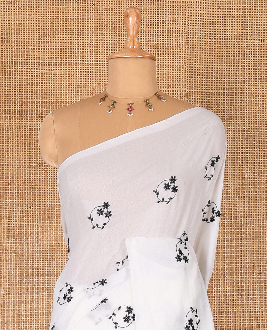 Borderless white and black floral motifs embroidered Khadi mul cotton saree with a matching plain blouse