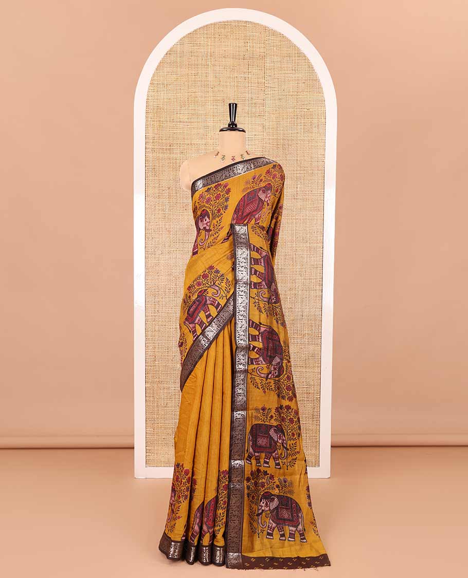 Mustard plain muslin cotton saree, contrast wedding-theme of floral and elephant motifs print, printed pallu, and a contrast buttas and zari bordered blouse