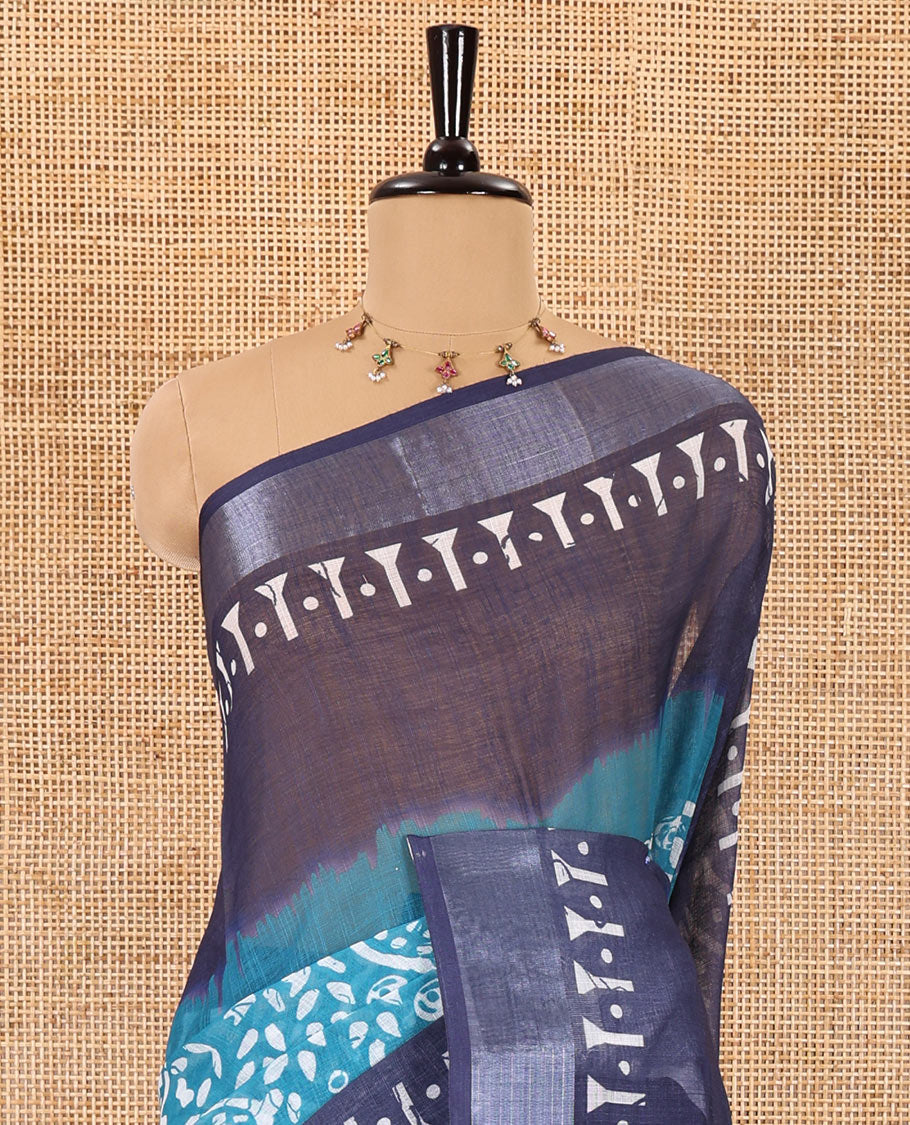 Blue batik style paisleys printed linen cotton saree, contrast batik printed with zari border, batik paisleys printed pallu, and a contrast printed blouse