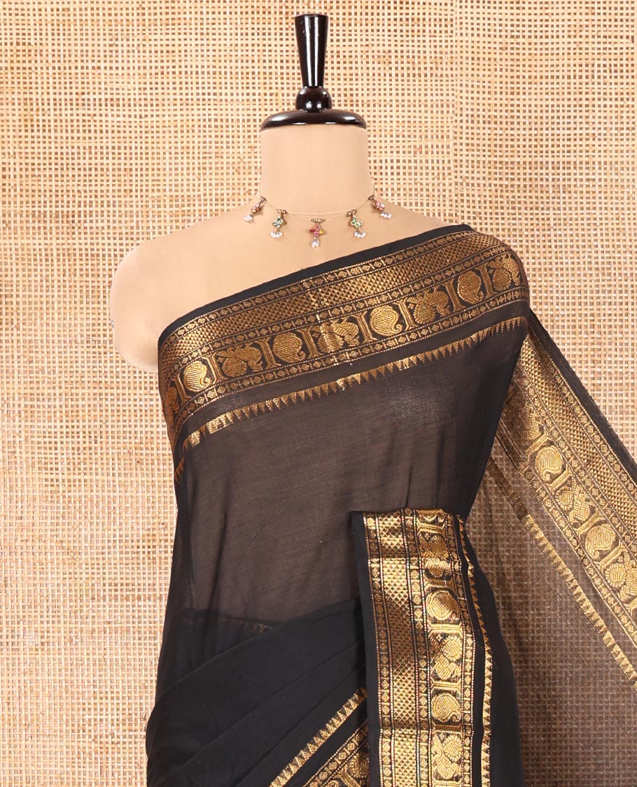 Black Plain Chettinad Cotton Saree, Highlighted by a Zari Traditional Border of Peacock and Paisley Designs, Subtly Striped Pallu, and Paired with a Matching Blouse