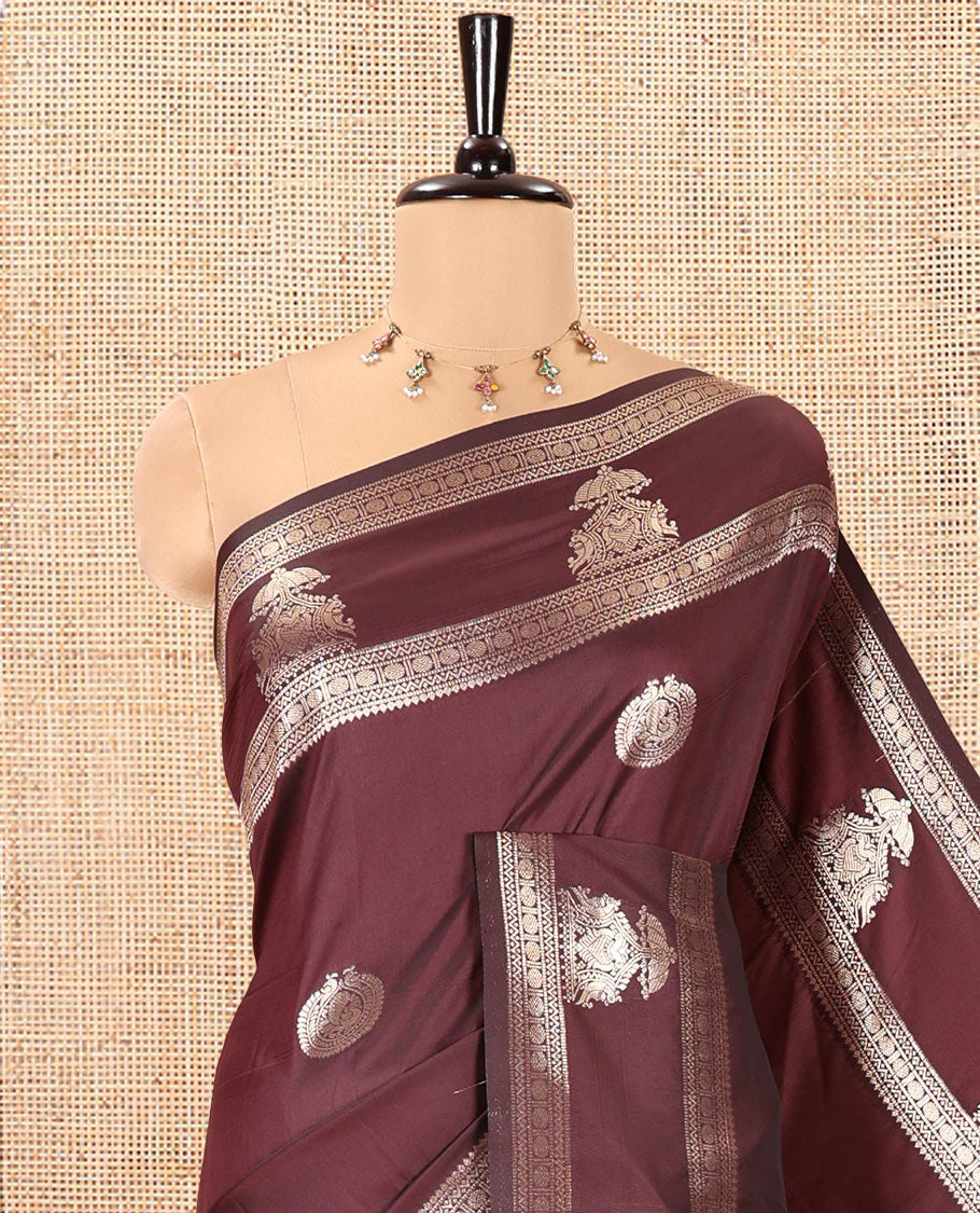 Brown Kanchi Soft Silk Saree, Artfully Woven with Peacock Zari Buttas All Over Its Body, Highlighted by Traditional Zari Design Border, Grand Jaal Pallu, and Paired with a Matching Blouse