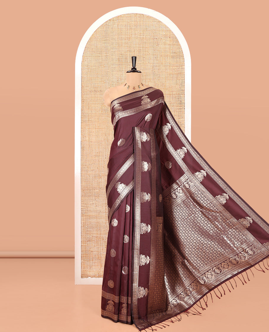Brown Kanchi Soft Silk Saree, Artfully Woven with Peacock Zari Buttas All Over Its Body, Highlighted by Traditional Zari Design Border, Grand Jaal Pallu, and Paired with a Matching Blouse
