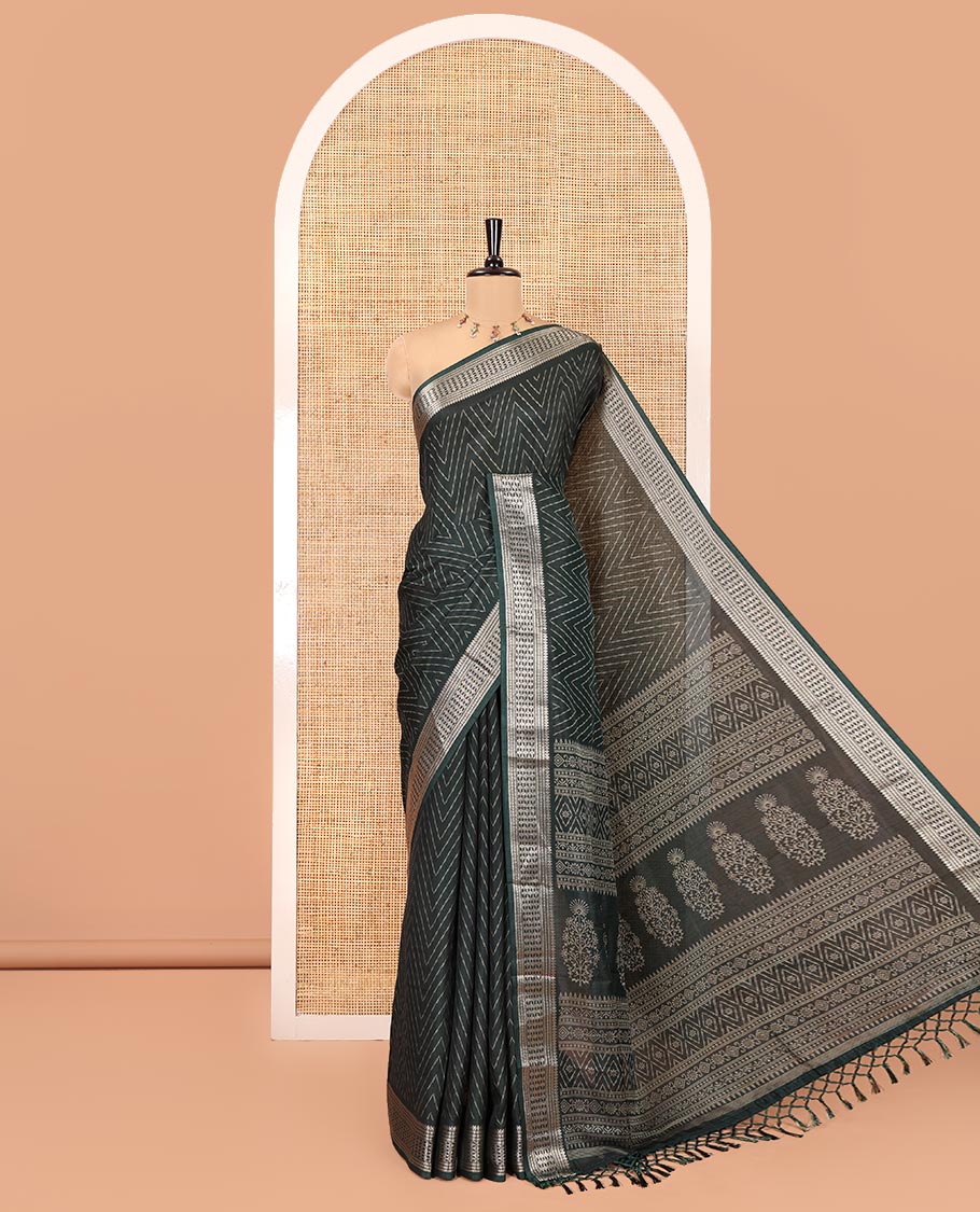Green Dola Silk Saree, Subtly Sparkled with Chevron Stripes on Its Body, Highlighted by Traditional Zari Design Border, Intricately Designed Pallu, and Paired with a Matching Blouse