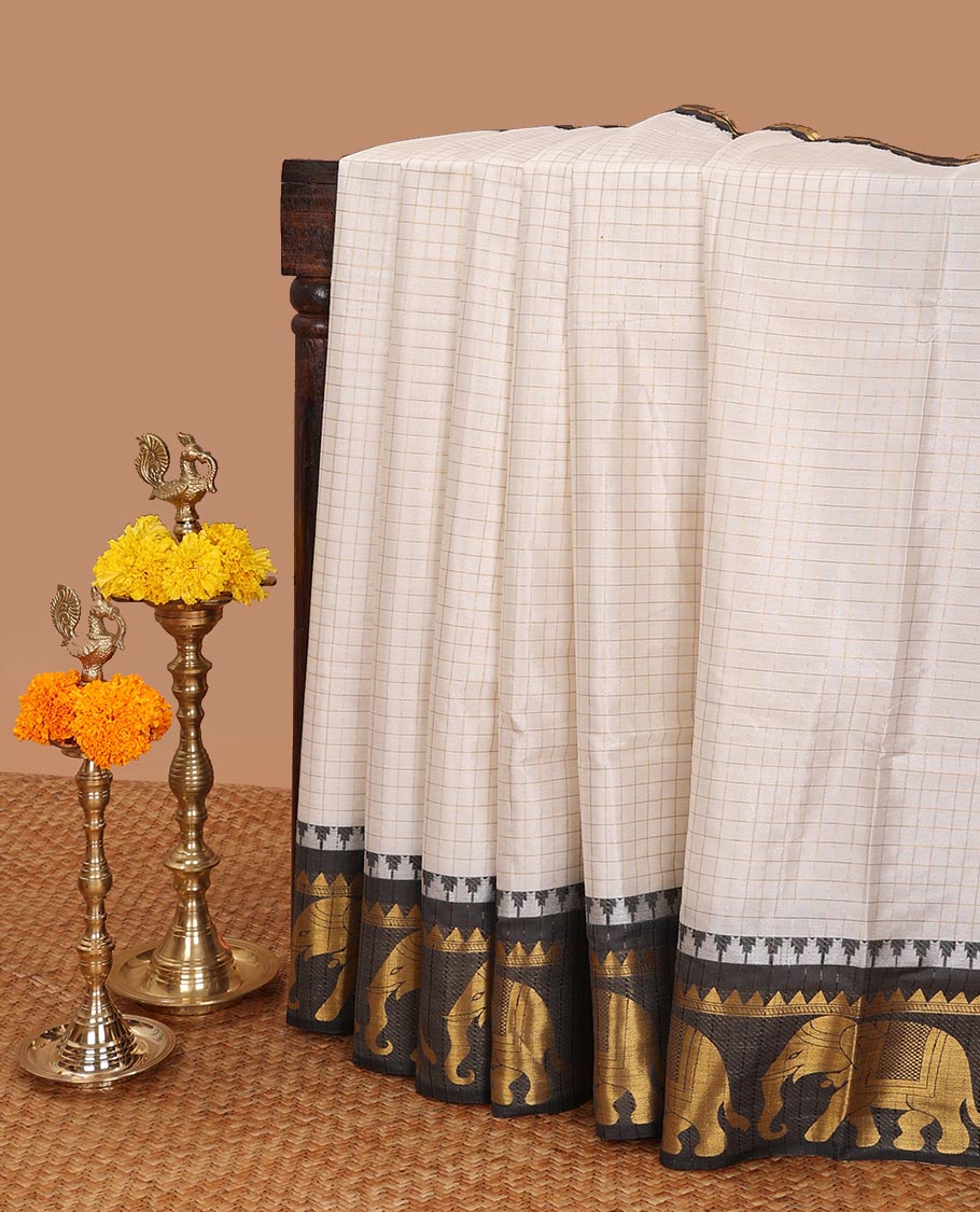 White zari checked design dola silk saree with contrast elephant design border & chit pallu along with checked design blouse