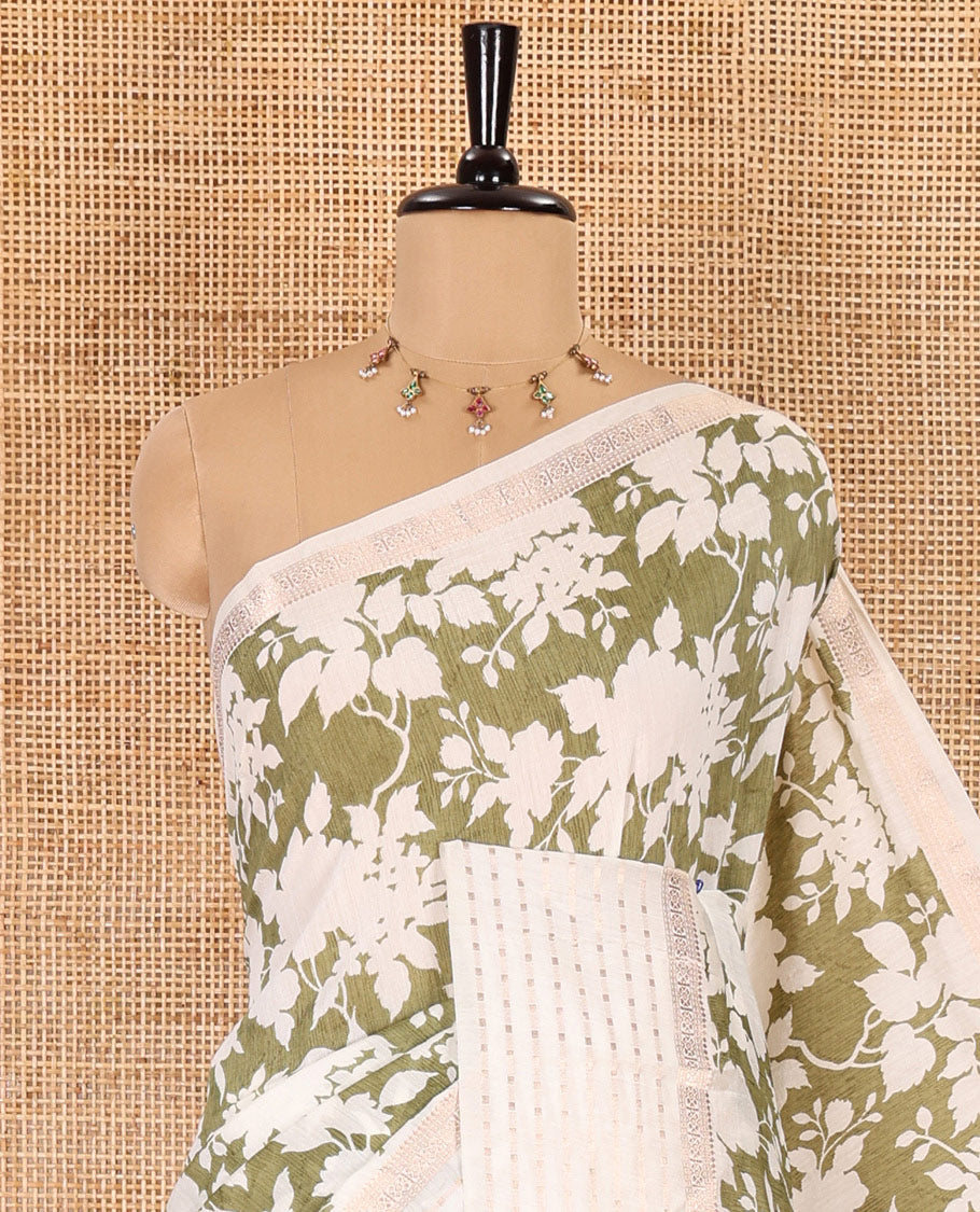 Olive green silhouette-style floral discharge printed Assam silk saree, contrast traditional zari border of rudraksham motifs, zari striped pallu, and a floral printed blouse