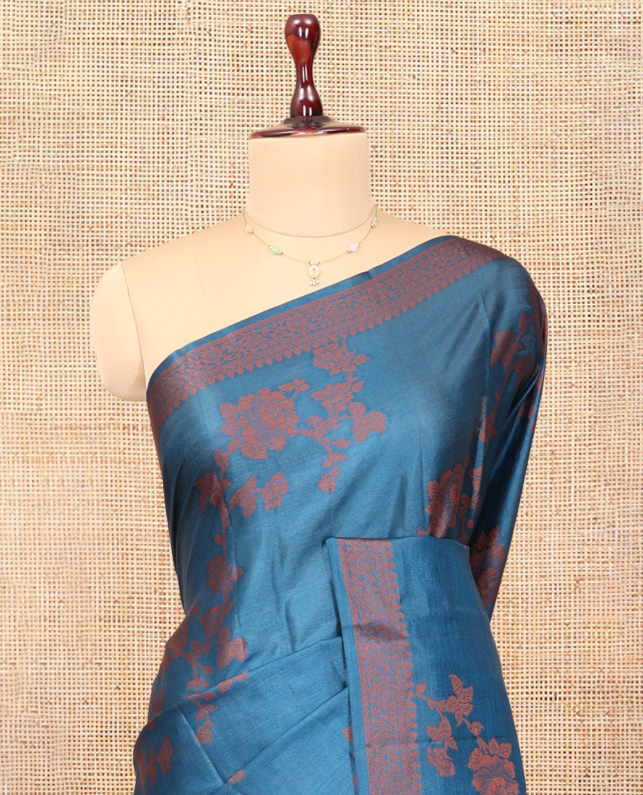 Blue Tussar Silk Saree Features Floral Designs, Sparsely Woven Zari Border, Intricately Designed Pallu, and a Matching Blouse