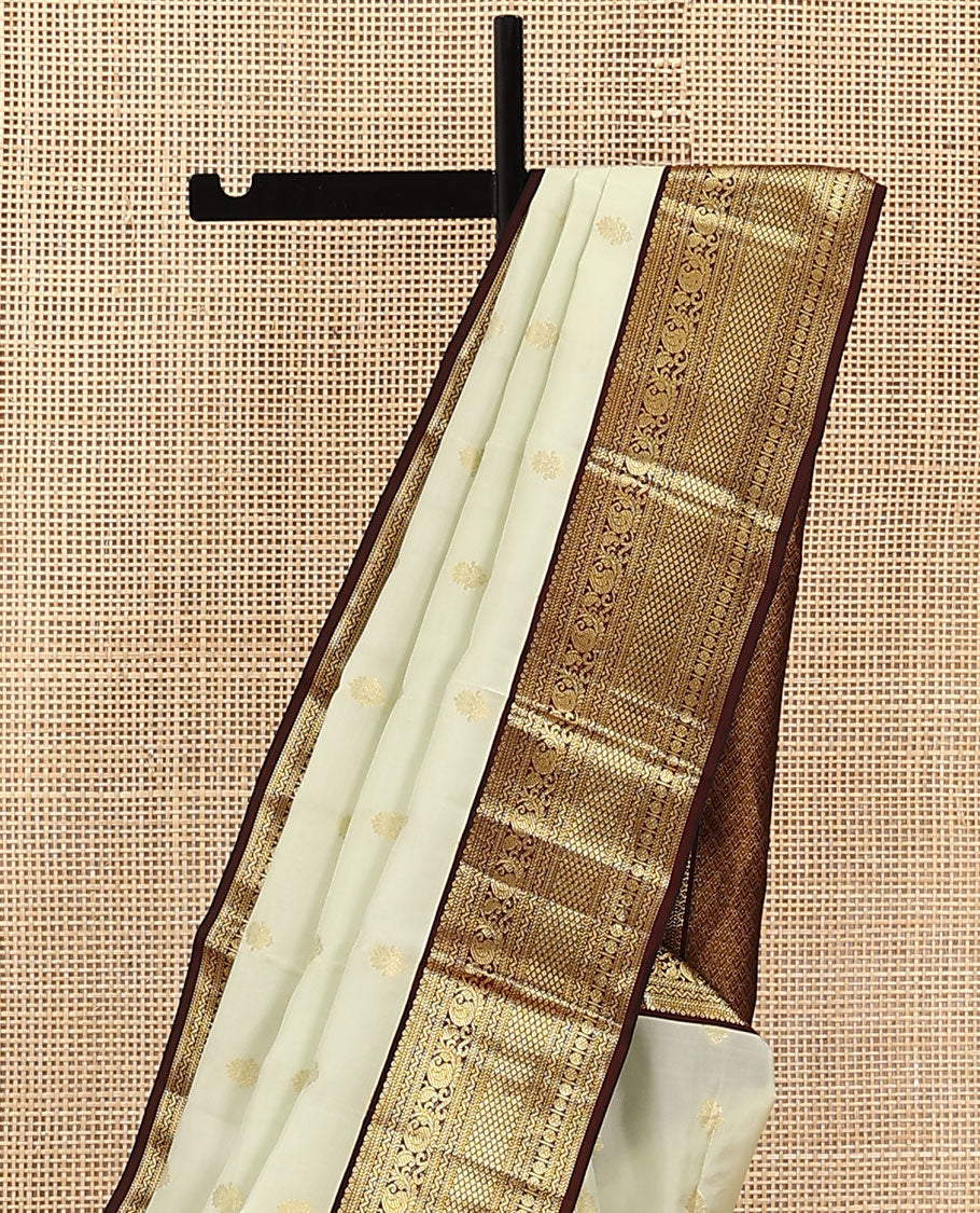 Cream Vasundhara Lite Silk Mix Saree, Enthralled with Zari Buttas on Its Body, Complemented by Contrast Border of Muthu, Banaras, Neli, Manga, Mayil Kann, and Rudraksham Designs, Grand Jaal Pallu, and Paired with a Contrast Blouse