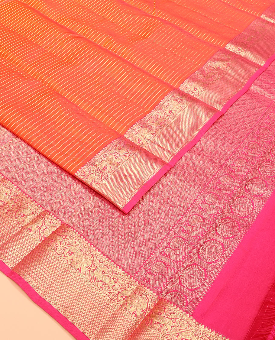 Orange zari striped Vasundhara silk saree, contrast border of thilakam mokku, yaanai, kuthirai, and kuyil kann designs, and jaal pallu
