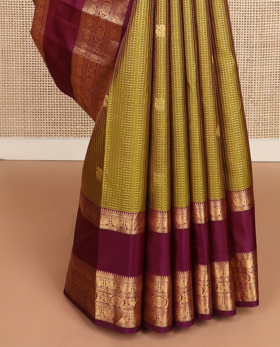 Green micro-checked with annam chakram buttas silk saree, contrast rettai pettu border of ara bogudi, muthu, banaras,iruthalai pakshi and poo chakram, and jaal pallu