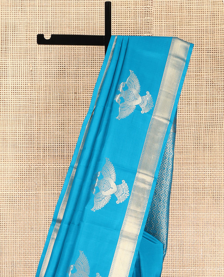 Blue Plain Vasundhara Silk Saree, Highlighted by Zari Border of Iruthalai Pakshi and Traditional Designs, Grand Jaal-Patterned Pallu, and Paired with a Matching Blouse