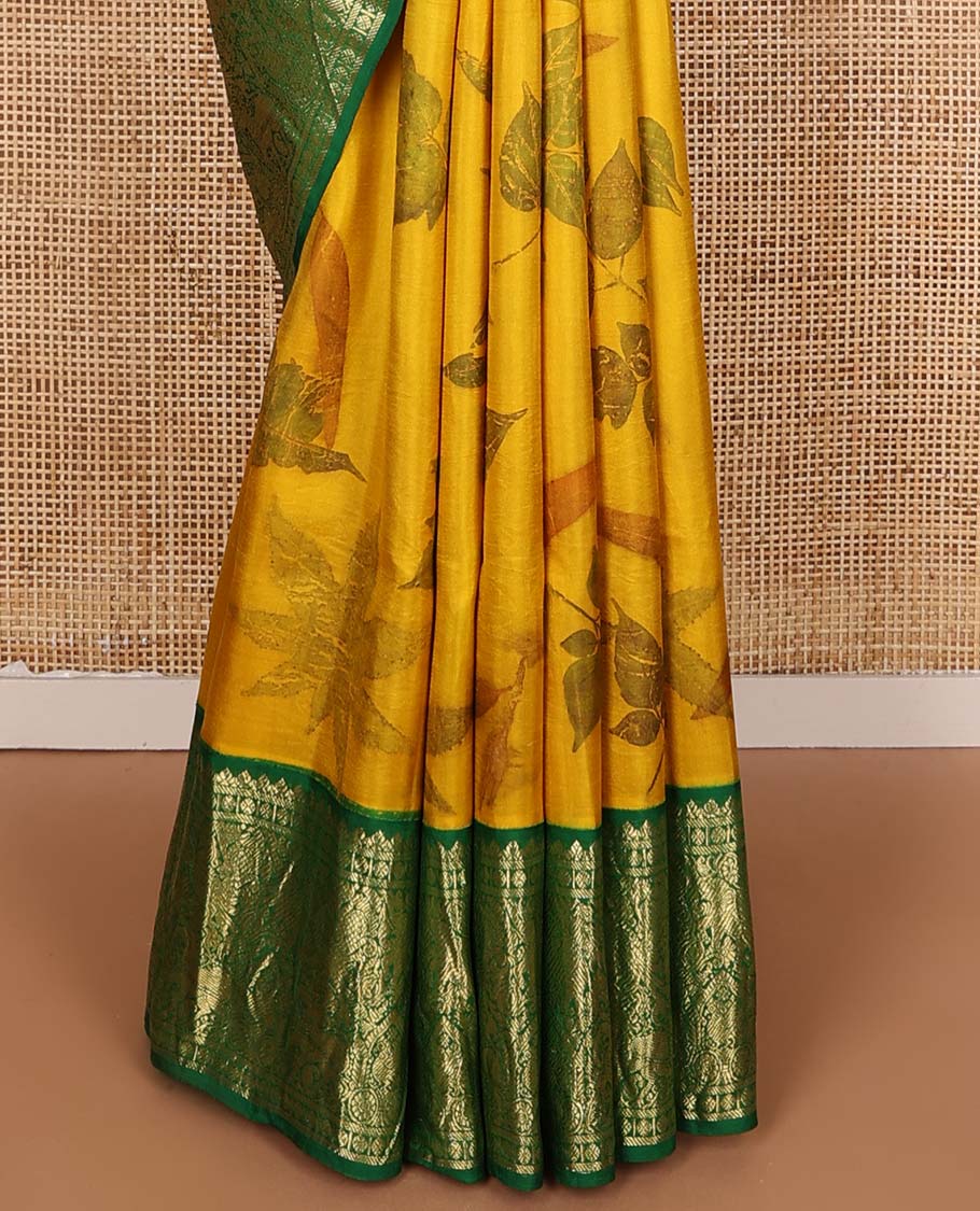 Yellow floral printed silks saree, contrast zari border of rudraksham, banaras, mayil, yaanai, and yaali designs, and jaal pallu