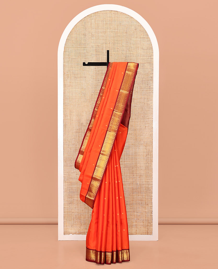 Orange Vasundhara Silk Saree, Enthralled with Zari Buttas All Over Its Body, Complemented by a Contrast Border of Manga, Poun, Neli, and Mayil Kann Designs, Grand Jaal Pallu, and Paired with a Contrast Blouse