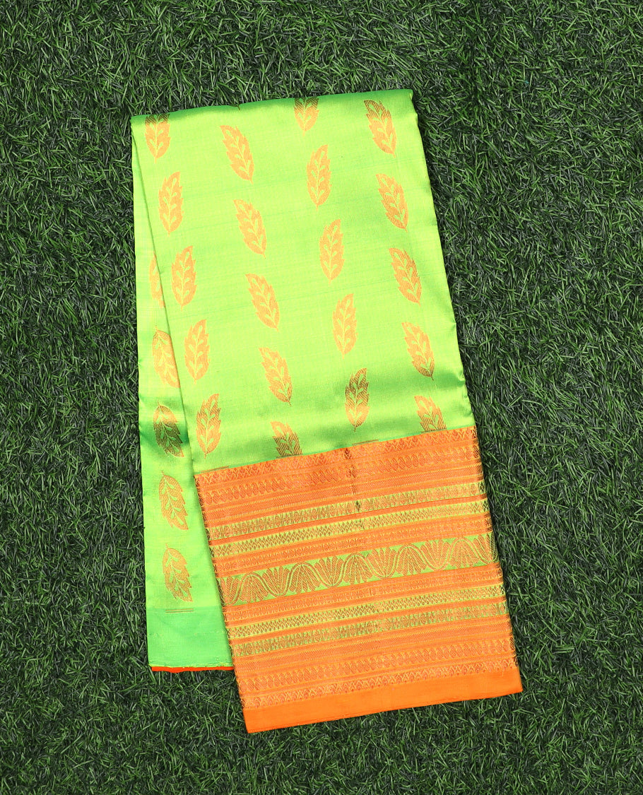 Green navarathna pavadai with leaf-shape buttas, contrast zari border & blouse of traditional zari designs