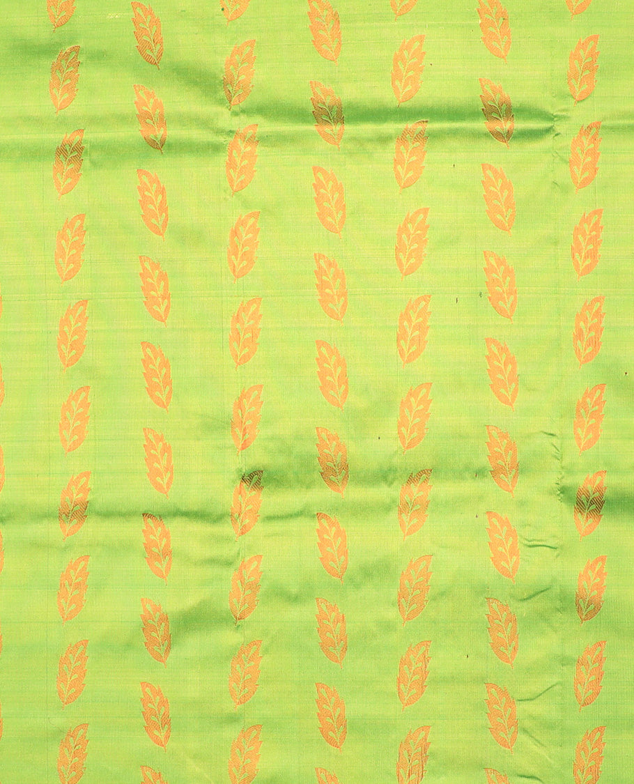 Green navarathna pavadai with leaf-shape buttas, contrast zari border & blouse of traditional zari designs